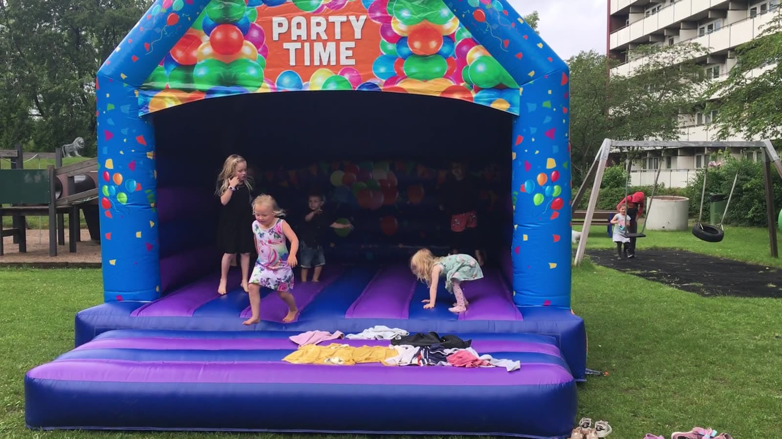 Kids jumping in a backyard bounce castle