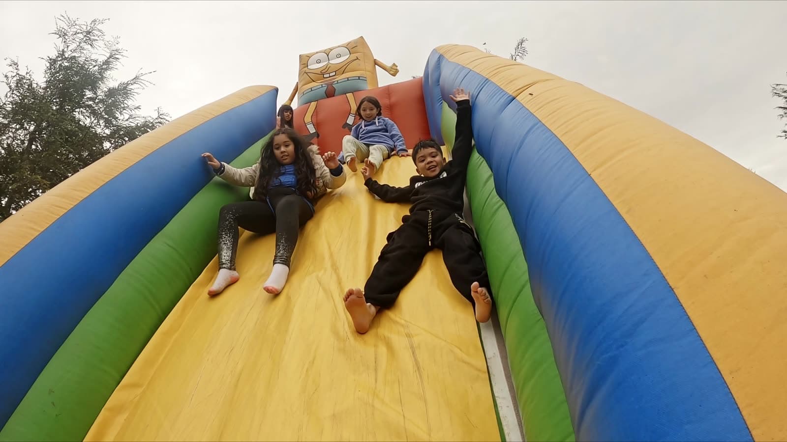 Kids racing down an inflatable slide